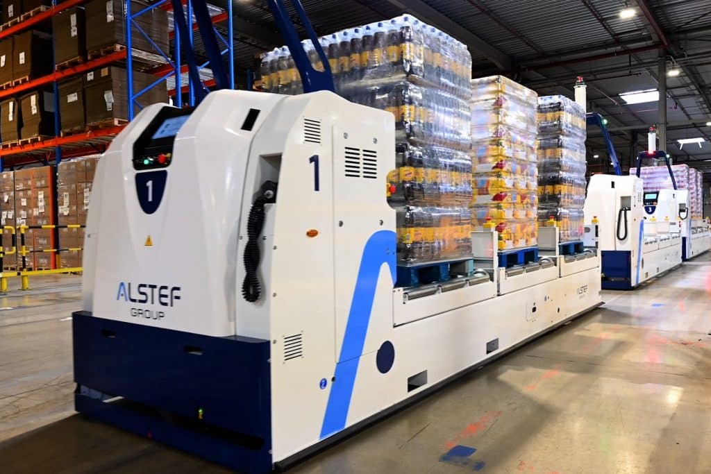 Powered conveyor carrying pallets